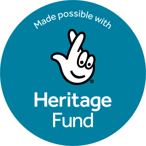 Blue circle with the text Made possible with Heritage Fund and a logo of a cartoon hand with crossed fingers above the words.